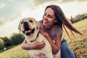 Young woman hugging her dog